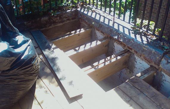 To reinforce the existing roof framing, the author sistered new joists alongside the old, supporting them in expanded masonry pockets. The old decking was replaced and a new EPDM roofing membrane installed.