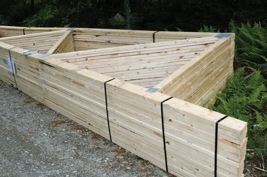 The carpenters set the mono-pitched roof trusses.