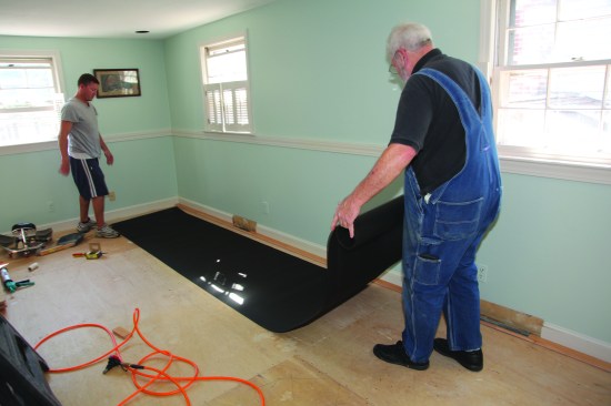Felt paper slows down any water vapor and adheres the flooring to the subfloor to minimize movement. Use of 15-lb. felt is often required by the flooring manufacturers.