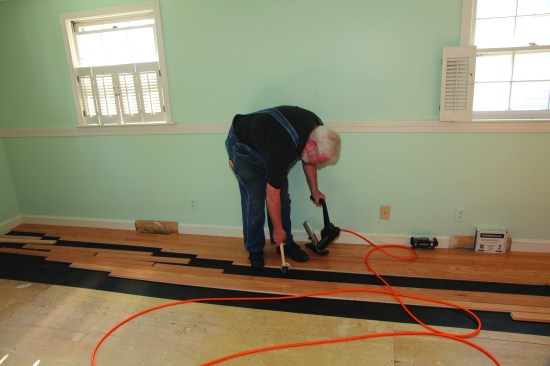The next step in the dance is tapping the strip snugly against the installed flooring.
