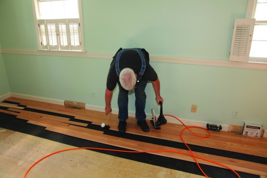 A tap on the end closes any gap between the boards. Now the board is ready to be nailed.