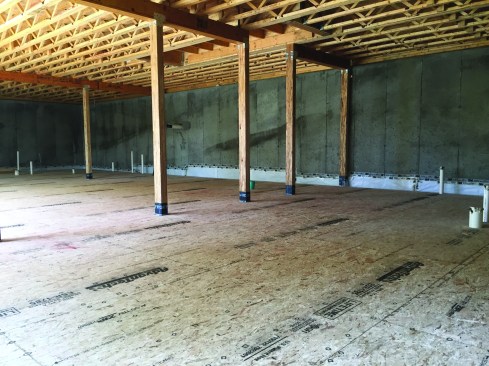 This layer was screwed to the first with 1 1/4-inch screws that would not
penetrate to the poly sheet below. Screws went in every 6 inches at the edges and every 12 inches in the field. When both layers were finished, the poly was secured to the wall with two rows of waterproof tape.Photo by Steve Demetrick