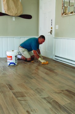 After letting the grout set up for a half hour or so, he went over the surface with a sponge and clean water, rinsing the spongefrequently; this left a light haze on the surface.