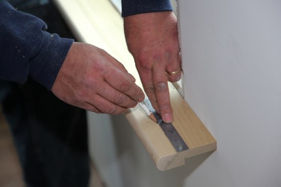 Connect the marks with a straight line to complete the layout for scribing the stool to fit against the wall. 