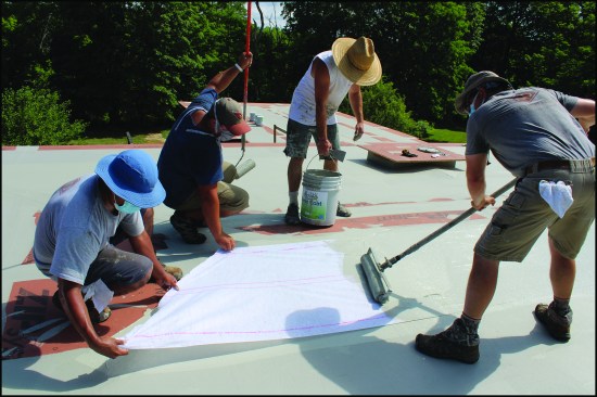 NDC crew members apply Acrylabs fluid-applied roofing to a 30-square roof located in New York’s Hudson River Valley.