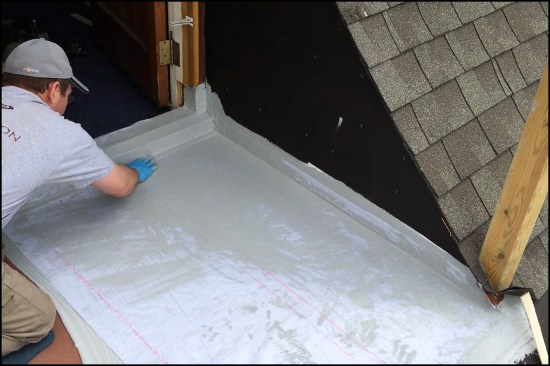 After the fabric has been carefully worked into the tack coat to smooth it out and remove air bubbles…