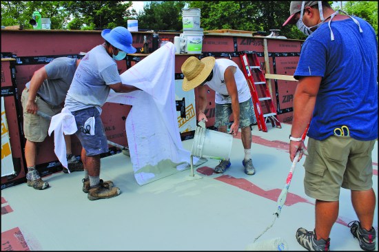 …taking care to smooth out wrinkles in the fabric as they squeegeed the coating to the desired 25-mil thickness.
