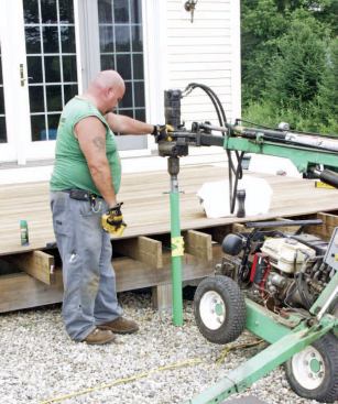 The screw piers can be installed with a small gas-powered machine and barely disturb the landscape.