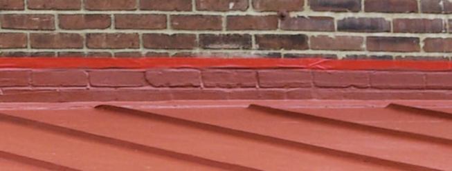 Because it is self-flashing and bonds to a variety of materials, Hydrostop provides seamless coverage between the addition's roof and the brick wall of the main house.