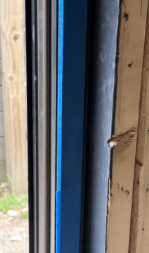After the shims are cut back, the window is protected by painter’s tape ... 