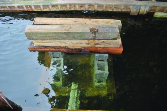 Concrete blocks and timbers needed to be piled on top of the cribbing to make it sink.