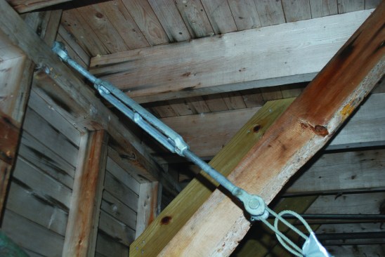 A cable and turnbuckly kept the building from racking as it was lifted.