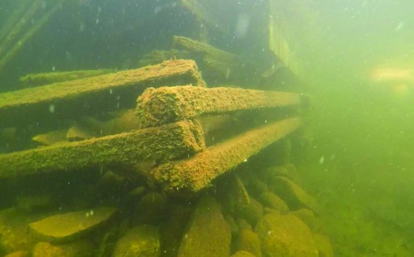 The boathouse was originally supported by rock piles surrounded by timber cribbings.