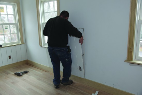 The piece was secured to the wall with construction adhesive and nails.