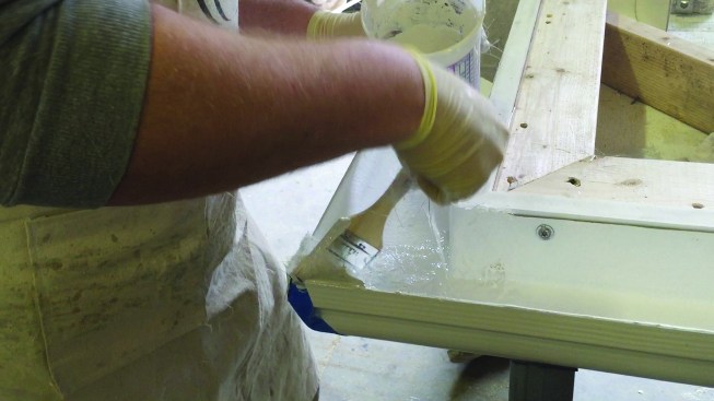 He “wetted in” the first layer of 2-ounce mesh with gel coat using a brush; then wetted in a second, thicker layer of chopped strand mesh.