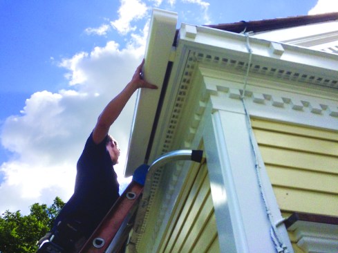 Then we attached spacer blocks (lined up with the building’s rafter tails), picked up the long gutter runs and put them in place.