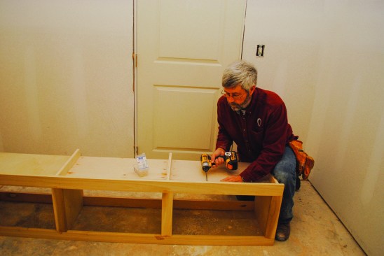 A spreader cleat along the  top of the cabinet provides  attachment for the plywood  back, as well as support for  the upper section when it  is installed. The face frame  attaches to the box with glue  and pocket screws, and  the plywood back completes  the assembly