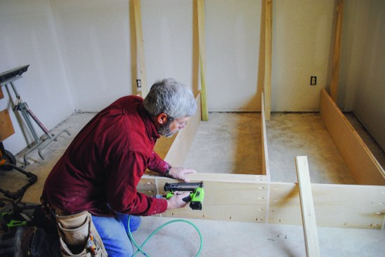 Then, at the top of each section, he glues and screws one-by cleats for attaching the unit to the wall. The cleats also add stiffness tothe assembly.