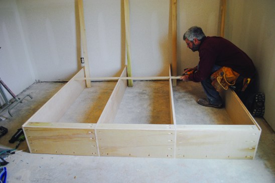 A second set of cleats act as spreaders and blocking to catch the bottom edge of the plywood back. To account  for the plywood, the two inboard verticals were cut 3/8 inch narrower than the outboard ones and the outboard verticals received  3/8-inch-deep rabbets along the inside edges. The extra depth gives the plywood back plenty of room.