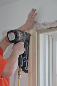 Finish nails tack the second side jamb in place until it is fitted with the head jamb.