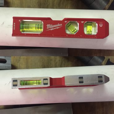 A new billet level is on the way, as well. This one is equipped with extremely powerful rare earth magnets and vials marked with 1/8" and 1/4" slope lines. What's cool about this level is that it can be read when laying flat ontop of pipe (right). It's also expected in October 2016 and will run around $38.