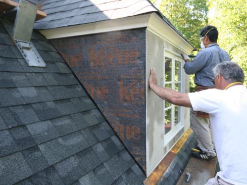 The Keene DriWall was fastened to the Zip wall with 3/8-inch staples, while the cement board was fastened to the sheathing with 1 1/2-inch-long Durock screws. To protect the exposed ends of the Durock, the stucco subs installed metal J-flashing along the bottom edge of the walls, as well as around all window and door perimeters. They “taped” the Durock seams with fiberglass mesh.