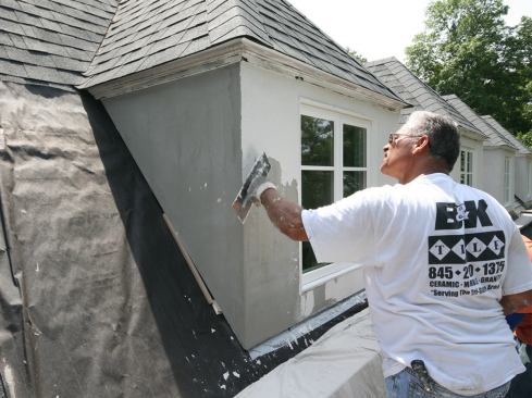 Using a plastic float, the stucco subs troweled on a thin coat of Total Wall’s Total Premium Elastomeric Finish over the surface, providing a medium sand-blast texture. The finish coat was tinted, so no further finishing was required.