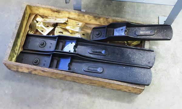 Cast iron plane bodies receive a powder coating when they arrive at the shop. Some of the powder coating will be removed as the casting is machined. Only those parts that are not machined will retain the powder coat color. These plane bodies have yet to be machined and are black on all surfaces.
