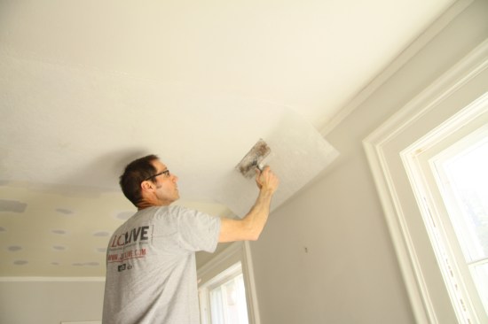 Position the first piece of wall reinforcement along a straight corner orchalked line and press it into the compound with a wide taping knife, working from the center toward the edges.