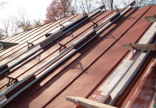 For easy movement over the roof, the installers used ingenious roof-bracket assemblies that hooked over the ridge.
