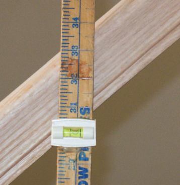 To make sure the yardstick is plumb when I take my measurements, I epoxy a bubble level at about the 30-inch mark, clamping the stick along the edge of a post I know to be plumb and using the bubble for reference as I do the gluing.
