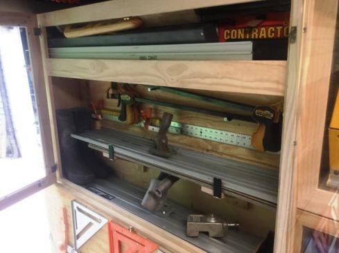 The first cabinet in contains magnesium bull floats, 36-inch clamps, and an assortment of other long items.