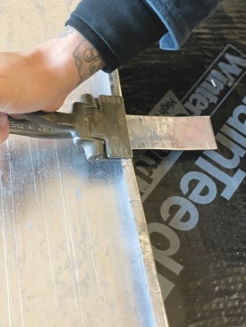 Metal tabs are folded into the standing seam every 12 to 16 inches.