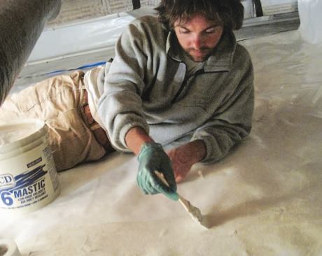 The self-sticking mesh tape held the overlapping plastic sheets in place as the mastic set up.