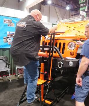 I’ve been trying to come up with ways to use this piece of equipment from 
Nomad Manufacturing in construction. It’s called the Elevator and it’s a creeper that allows you to hover above the work area. The mechanic climbs up from the step, pulls a lock handle, and then pivots the bed forward so he can lie horizontally out over the engine. Check out the next photo and you’ll see what I mean.