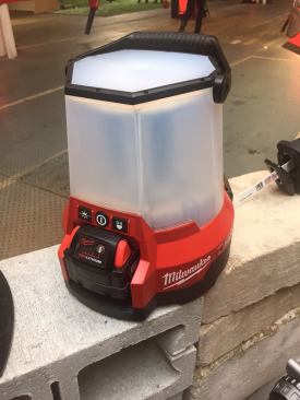 Milwaukee announced that jobsite lighting is a category that they will continue to grow. One of their big “wow” announcements was this compact site light, which they refer to as “Radius LED Compact Site Light”. It’s portable, runs on M18 battery OR AC, and is very durable (one of the editors present actually dropped it on its head from a little over 4’ without issue). The outer polycarbonate lens didn’t break when a 15 lb weight was dropped directly on it. It comes with a hook built into the bottom so it can be hung overhead from pipe or wood framing, and it has AC input and output so it can be connected in a series. Milwaukee says you can run 15 of these at one time on a 15 Amp breaker. AC input does NOT charge the battery, however, if the power goes out and a battery is in, the light will switch to battery mode instantly. The light has three modes; high, medium and low – with a max output of 4400 lumens. It also has three directional modes: Side A, Side B, or Both. LEDs are warrantied for life as long as they’re not damaged. Each light comes equipped with a 3.5’ aluminum cable so it can be locked up on site. When equipped with a 9 Ahr battery the light will run for 2 hrs on High, 4 hrs on Medium, and 8 hrs on Low. The best feature of this light might be its OneKey compatibility, Milwaukee’s mobile app. With OneKey you can turn the light on and off from your phone. But that’s just the beginning. You can also set a sleep timer for the light, and create a schedule for it much like programmable thermostats. These features only work when the light is plugged into AC power, but it’s still a super cool and very useful feature. Even when lights are run in a series, each light is controlled individually within OneKey. The Radius LED Compact Light will be available with or without OneKey compatibility. MSRP: $299 (without OneKey). Expected: July 2016. Radius LED with OneKey is expected in October; no price information is available yet.