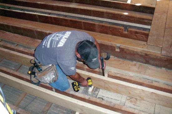 As with the first joist, I measured and cut a block to fill the gap between the bottom of each joist and the wall below. After slipping the block under the joist and screwing it to the plate ...