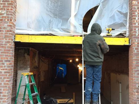 We needed to frame out the masonry opening to receive the new doors. Rather than infilling with a bunch of 2-by stock, we decided to install a couple of LVLs. We ripped the LVLs to match the existing joist depth, taking off about &frac34; inch. We weren’t too concerned about compromising their structural integrity; in this case, the LVL was essentially acting as blocking. However, the clients are thinking about adding a deck off the kitchen in a year or so. The LVL will provide good anchoring for a ledger, if they choose to do this.