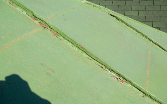 The contrasting green primer coat that came next revealed areas that needed further attention with a wire brush.