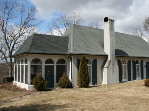 Last November, my company began remodeling a French cottage–style home in the Hudson River Valley region of New York. Built in the late 1960s, the existing wood-framed structure was set on a slab-on-grade foundation. It had half-round transoms above the doors and windows, a cementitious exterior veneer, and a hip roof with steep, unequal pitches and a curved “flare” at the eaves—all in keeping with its architectural style.