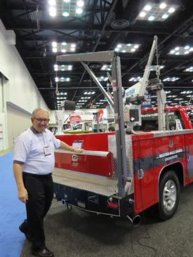 Western Mule is one of a number of companies that make cranes that fold into the bumper when not in use. This is their A-Series crane. Models are available to lift between 750 and 2,500 pounds. 
Click here for video of how the crane works.