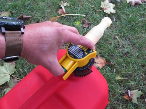 No-Spill's can is plastic and requires you to depress a spring-loaded button while dispensing fuel. The spring is stiff and your thumb will get tired when you're emptying the full 5 gallons.