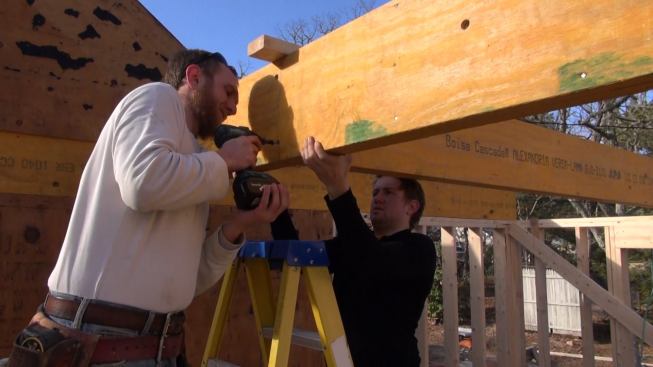 Hill drives six-inch FastenMaster structural screws to connect the two double-LVL beams together and pull the connection snug. Next, this joint will be secured with another Simpson steel connector.