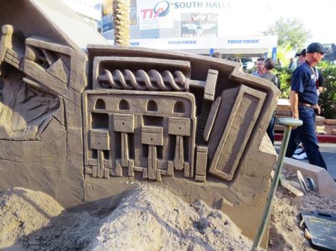 Now that’s a detailed sand sculpture, a cutaway that includes the radiator, cam shaft, engine block, and pistons!