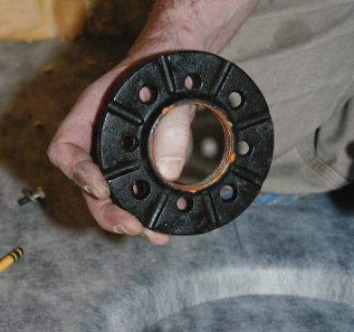 Note that the bottom of the clamping ring is grooved to allow water to weep into the drain.