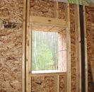 An interior view of one of the small north-facing window openings at the rough framing stage.