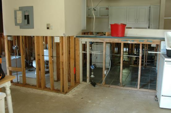 The bathroom fixtures remain, but the entire tile wall around the tub was removed. The ceramic tile floors in the kitchen and bath are sound so they were left alone.