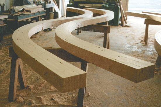 Curved glulam lumber in Alaskan cedar.
