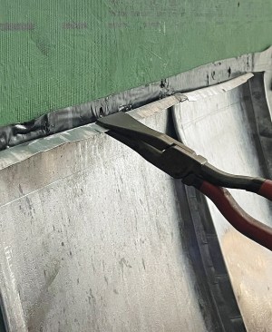 At the transition between the metal roofing and the wall, the tops of the pans are folded over ...