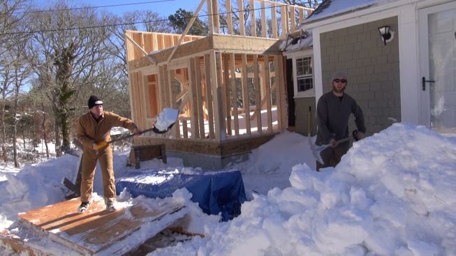 Farther from the shore in Harwich on Cape Cod, framing contractor Mike Hill and carpenter Russ Laffin shoveled out the job site after the storm. With more snow on the way, Hill said, he would probably spend a few days on some inside work at another location.